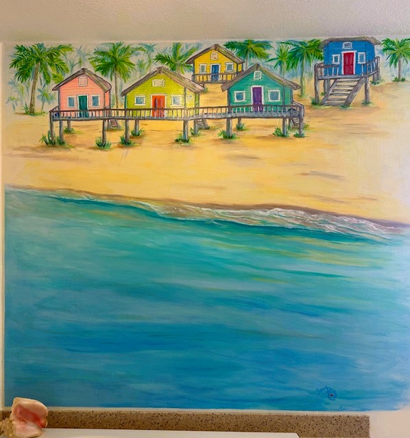 Shanty Town — colorful beach cottages on stilts along a tropical shoreline with palm trees